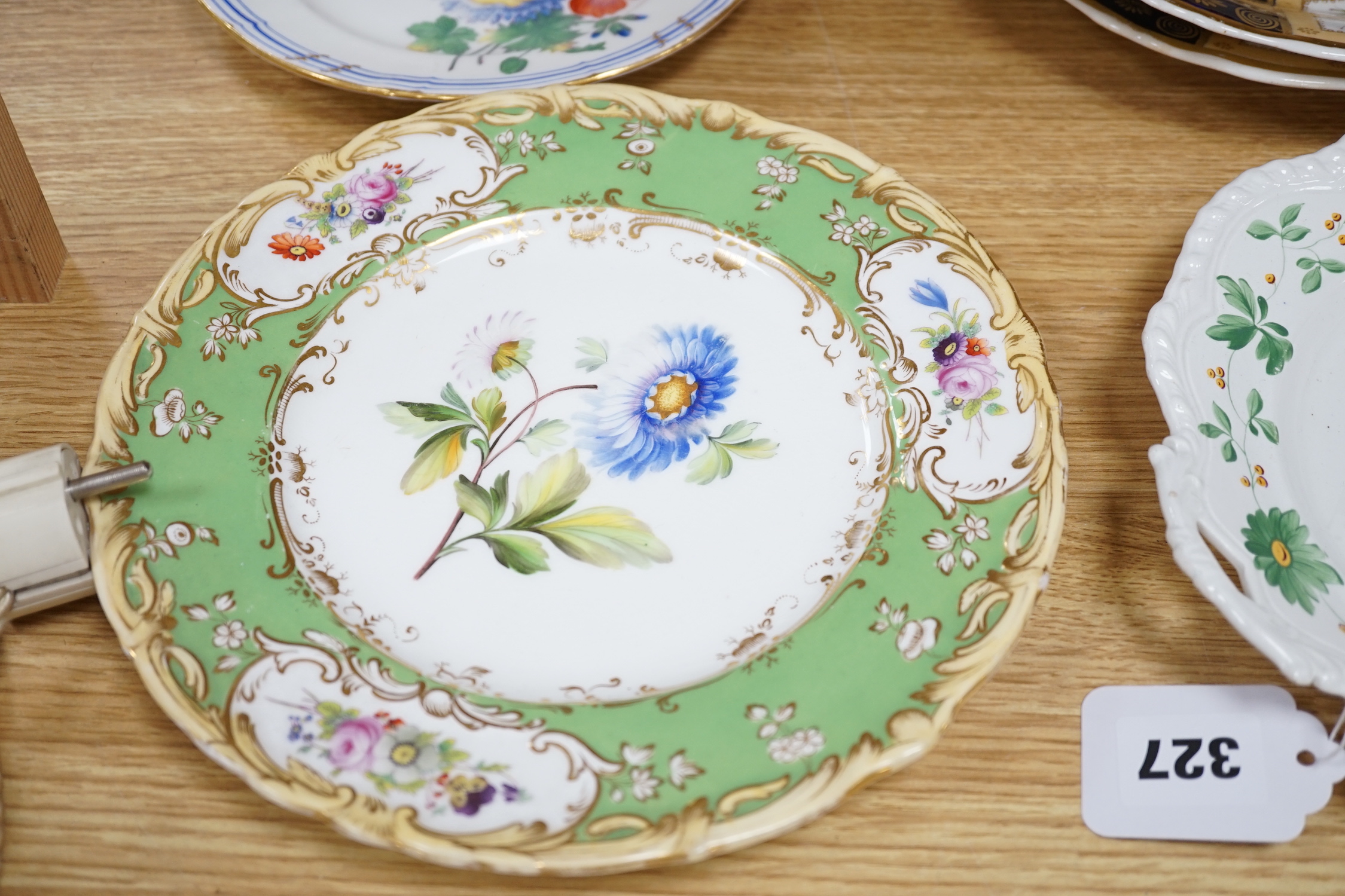 A collection of early 19th century decorative porcelain painted with flowers and a gilt blue ground plus other (12)